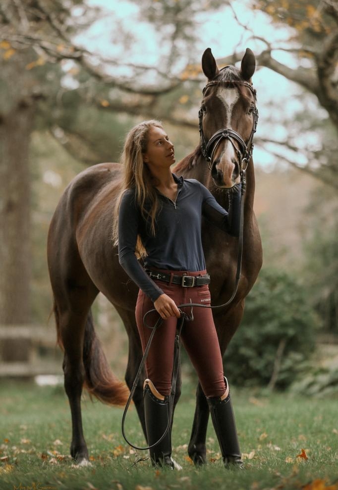 Leslie Ann McGowan standing with her horse
